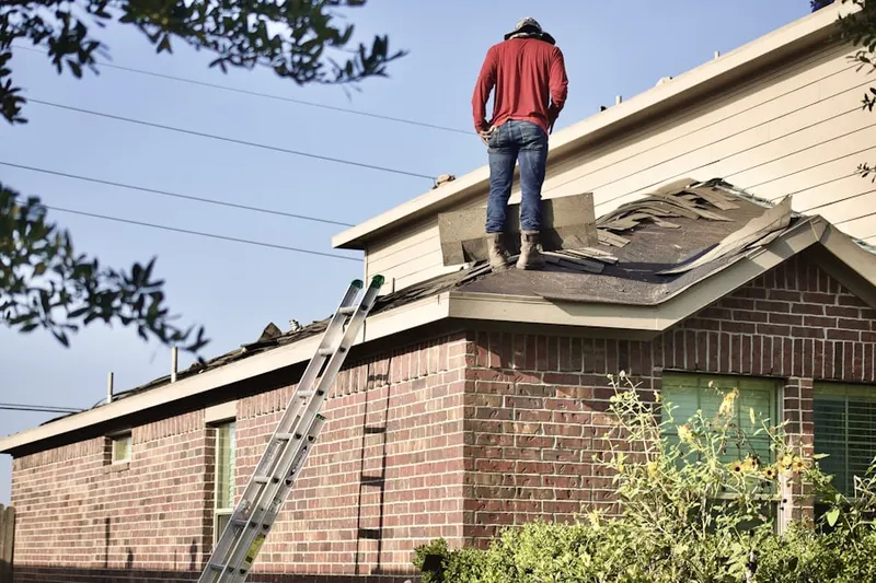 Professional roofer working on a residential roof in Breezeswept Park Estates